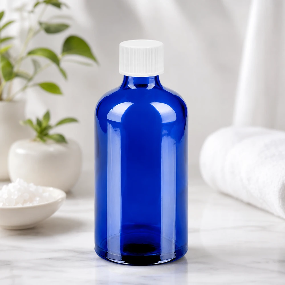 Botella de vidrio compacta de 100 ml en azul brillante con tapón blanco de 11 mm para uso diario