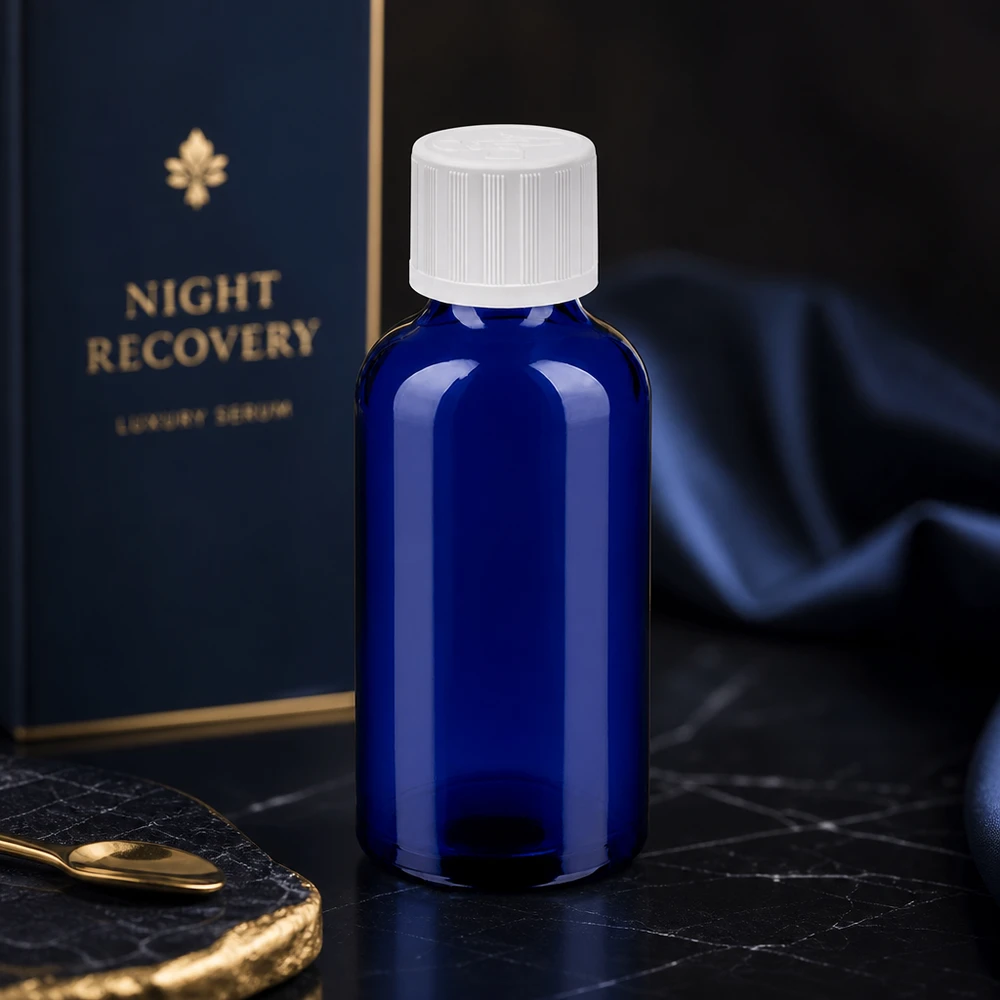 Frasco compacto de vidrio de 50 ml con protección UV gracias a su color azul y tapón blanco