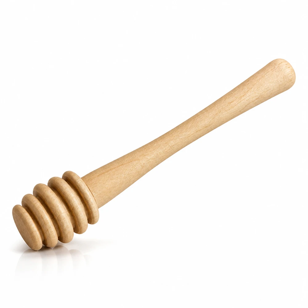 Cuchara de miel de madera de arce con extremo acanalado para la extracción de miel en porciones sobre fondo blanco de estudio.