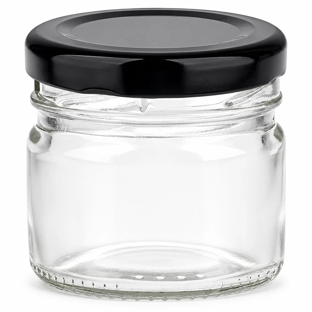 Frasco redondo de cristal de 33 ml + tapa BasicSeal negra UNiTWIST Frasco redondo de cristal de 33 ml con tapa BasicSeal negra, vacío y transparente sobre fondo blanco