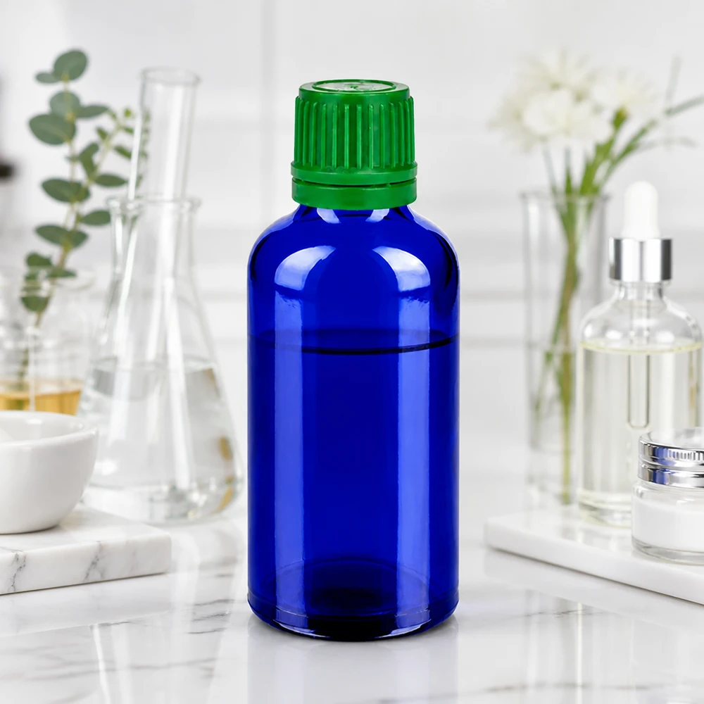 Frasco fotoprotector de 50 ml de vidrio azul con protección UV y tapón verde a prueba de niños