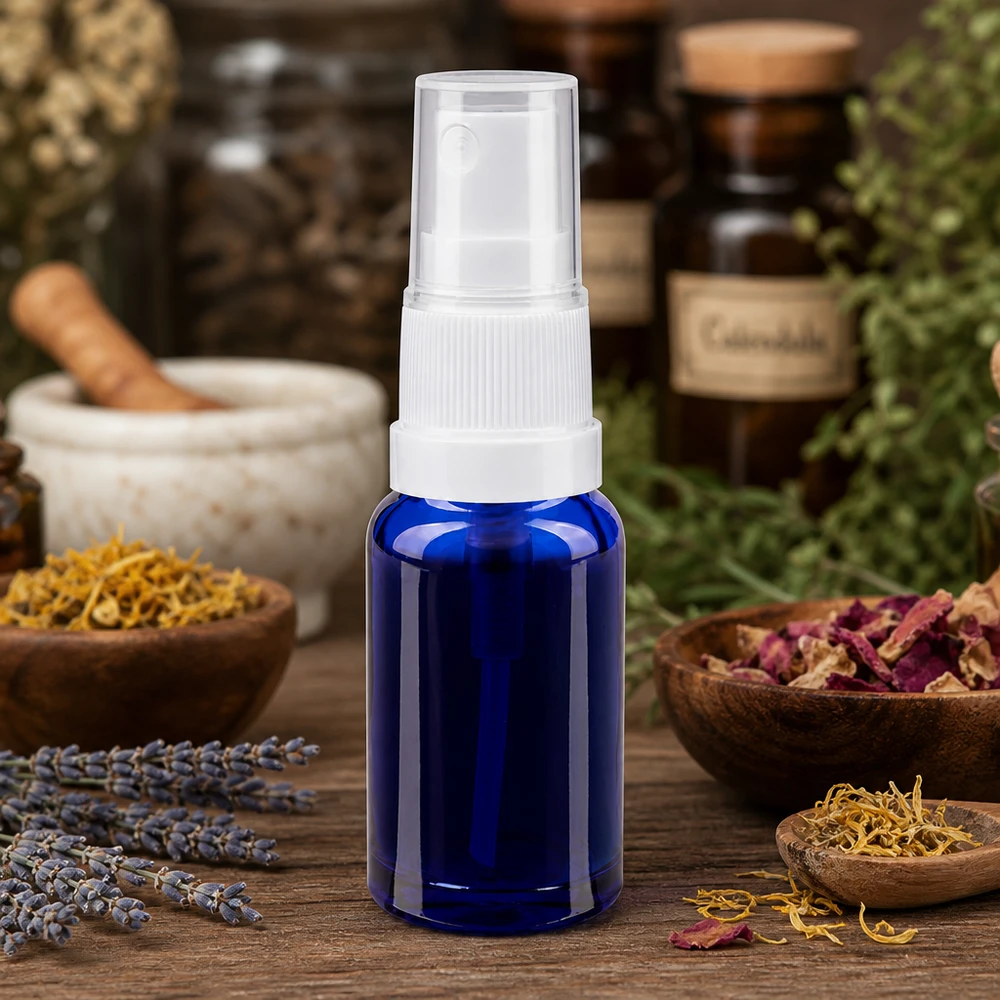 Frasco pulverizador de 10 ml de cristal azul de farmacia con atomizador blanco, rodeado de hierbas medicinales y lavanda