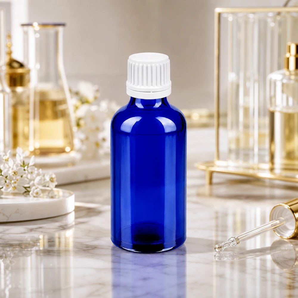 Botella 50ml tapón rosca 11mm blanco cierre inviolable BlueLine UT18/50 Frasco boticario de 50 ml de vidrio azul con tapón cuentagotas blanco para una dosificación precisa