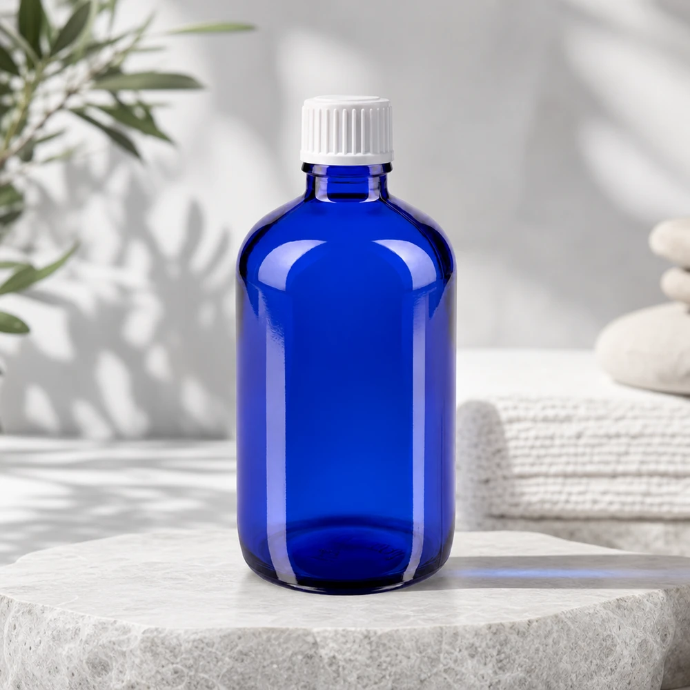 Frasco de farmacia azul de 100 ml con protección UV y tapón blanco estándar para aceites esenciales