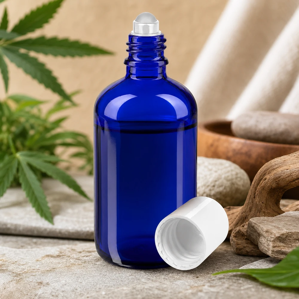 Botella de farmacia azul 100ml tapón roll-on blanco Frasco de farmacia azul de 100 ml con aplicador de bola, con piedras naturales y hojas de cannabis