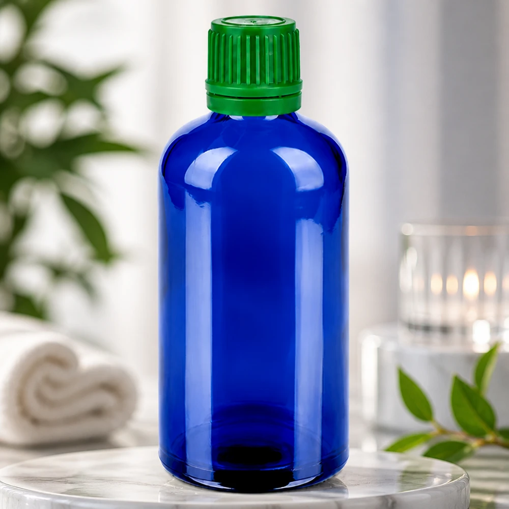 Botella 100ml 11mm tapón rosca verde precinto BlueLine UT18/100 Frasco de vidrio compacto de 100 ml en azul con tapón verde para una dosificación precisa y un almacenamiento seguro