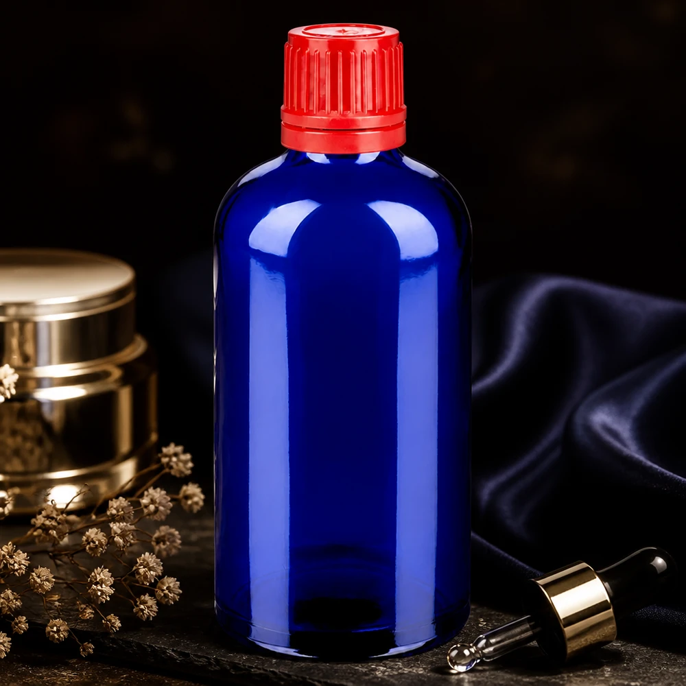 Botella 100ml 11mm tapón rosca rojo cierre inviolable BlueLine UT18/100 Elegante frasco cuentagotas BlueLine UT18 de 100 ml de vidrio cobalto con tapón rojo a prueba de manipulaciones