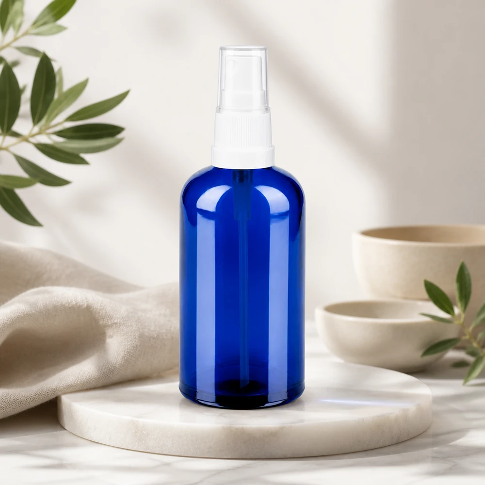 Frasco pulverizador de 100 ml de alta calidad fabricado en vidrio azul con diseño transparente para un cuidado natural