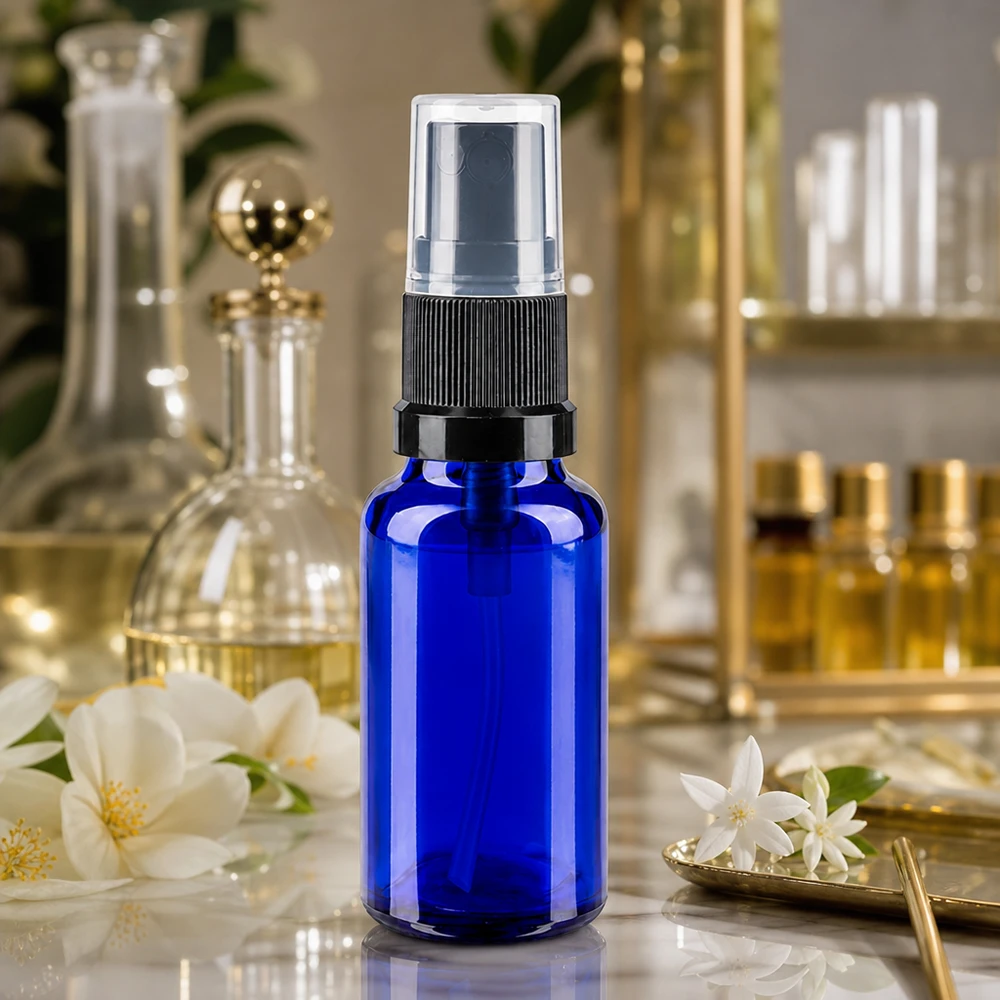 Botella pulverizadora azul de 20 ml de cristal de farmacia con pulverizador negro y tapón protector transparente