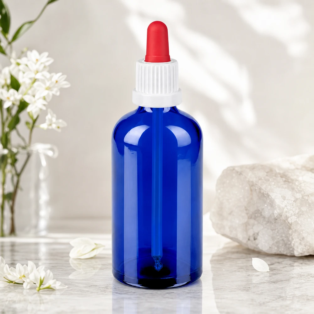 Elegante botella de cristal azul de 100 ml con tapón de rosca blanco y pipeta roja para aceites esenciales
