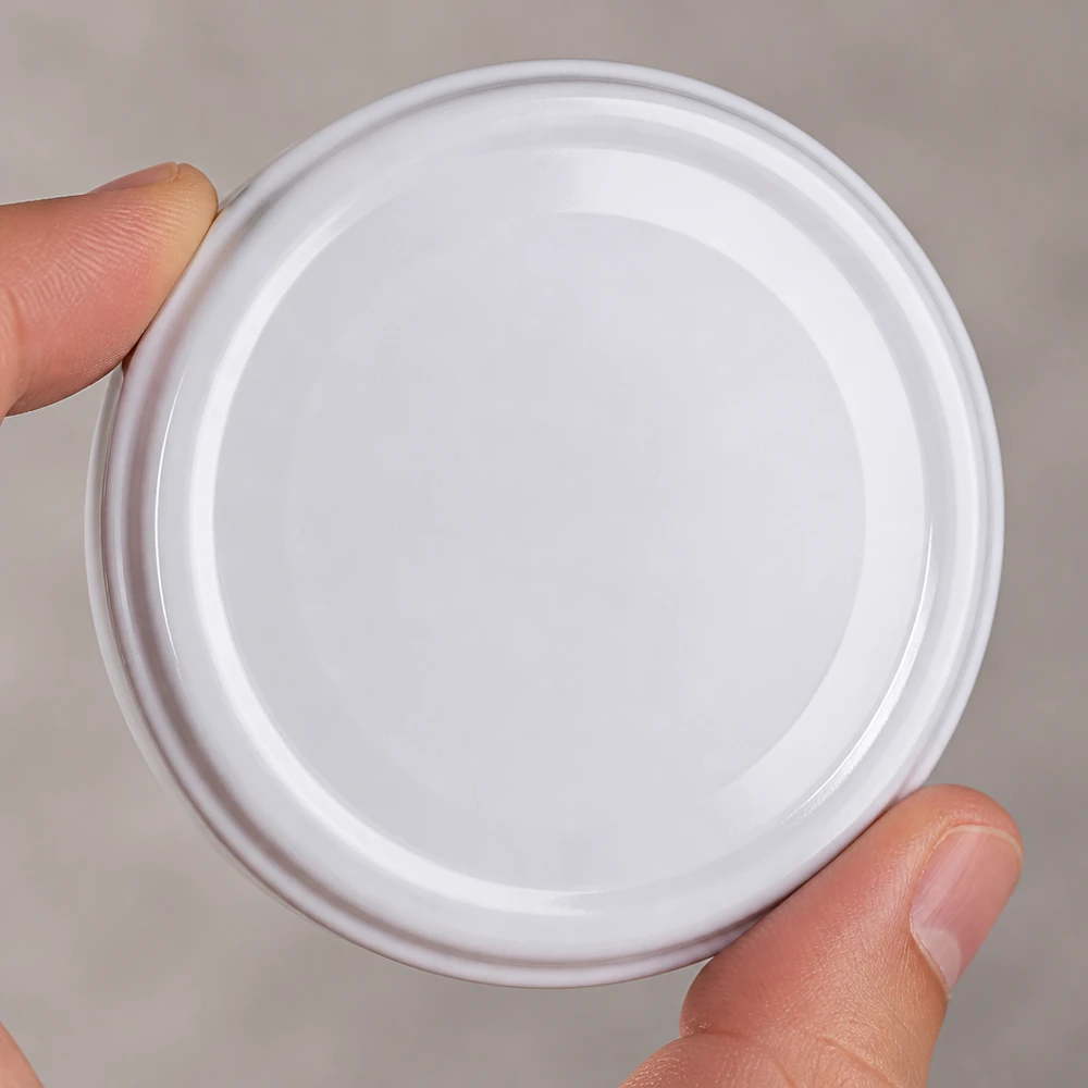 UNiTWIST TO43: tapa blanca para tarros BioSeal sin BPA, vista desde arriba, superficie lisa