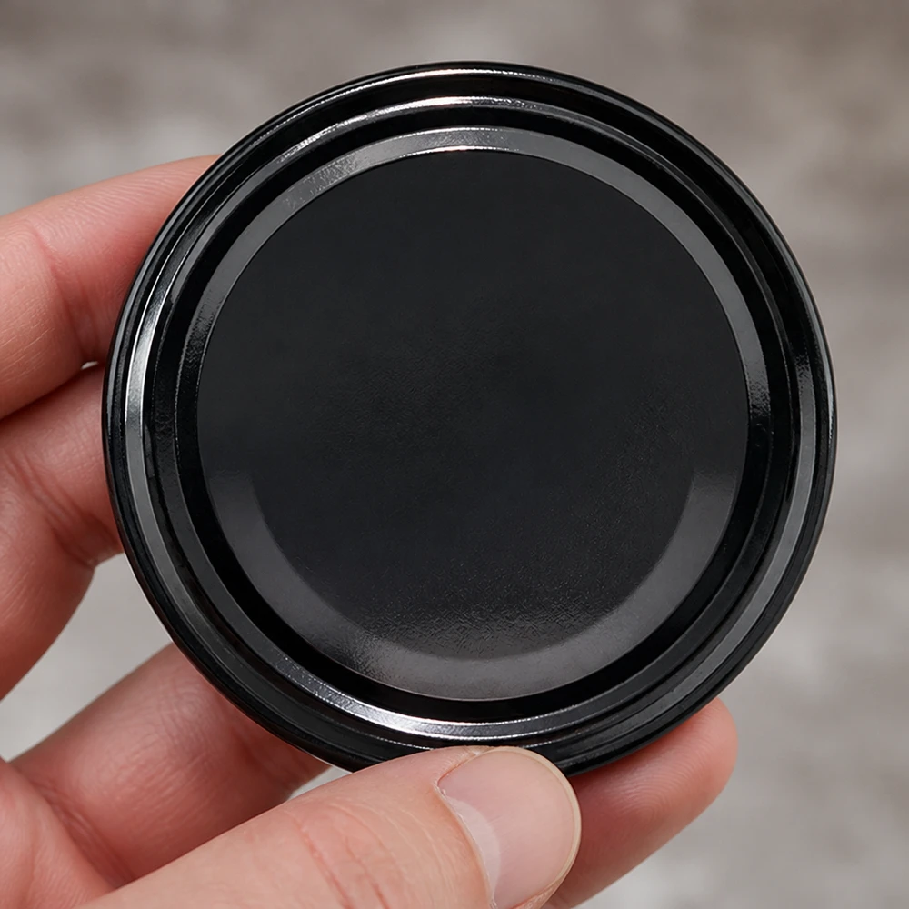 UNiTWIST TO82 negro, BioSeal, sin BPA, UNiTWIST Vista superior de la tapa de rosca UNiTWIST TO82, negra, BioSeal, sin BPA, superficie brillante, 82 mm de diámetro