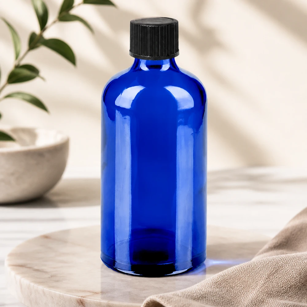 Frasco cuentagotas azul cobalto de 100 ml con tapón negro estándar para el almacenamiento seguro de sustancias fotosensibles